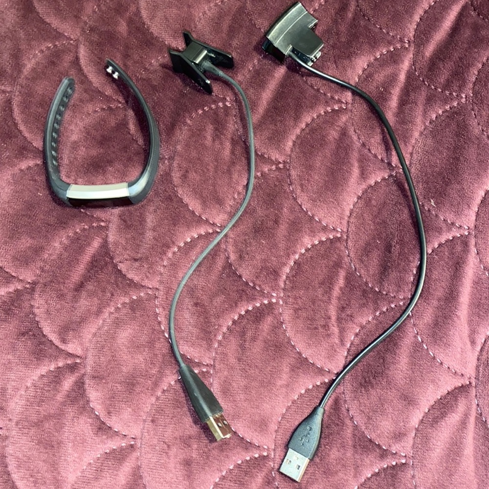 Black Fitbit alta wristband and charger cables